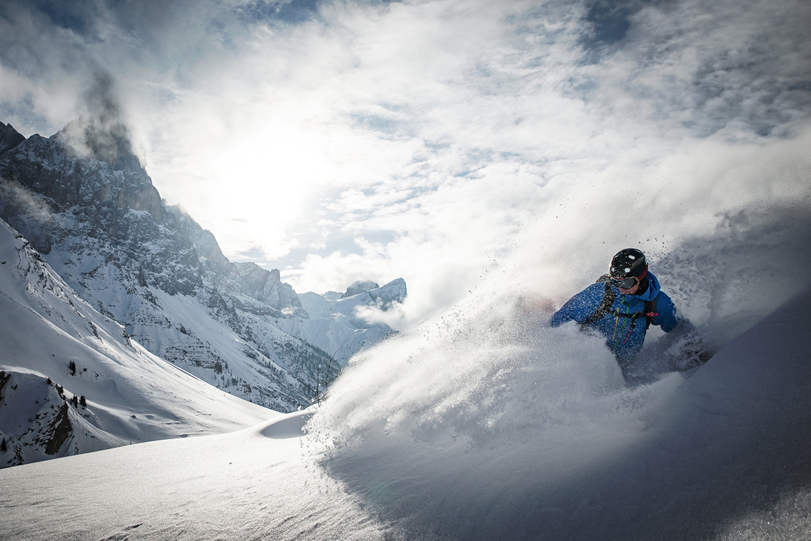 Action skiing at the Rolle Pass A skier does action skiing at the Rolle Pass in the Dolomites, Italy.